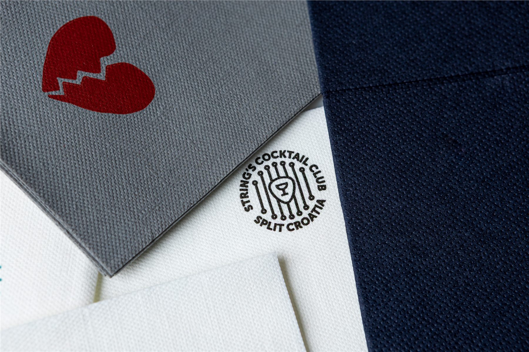 Napkins printed with client logos in grey, navy and white