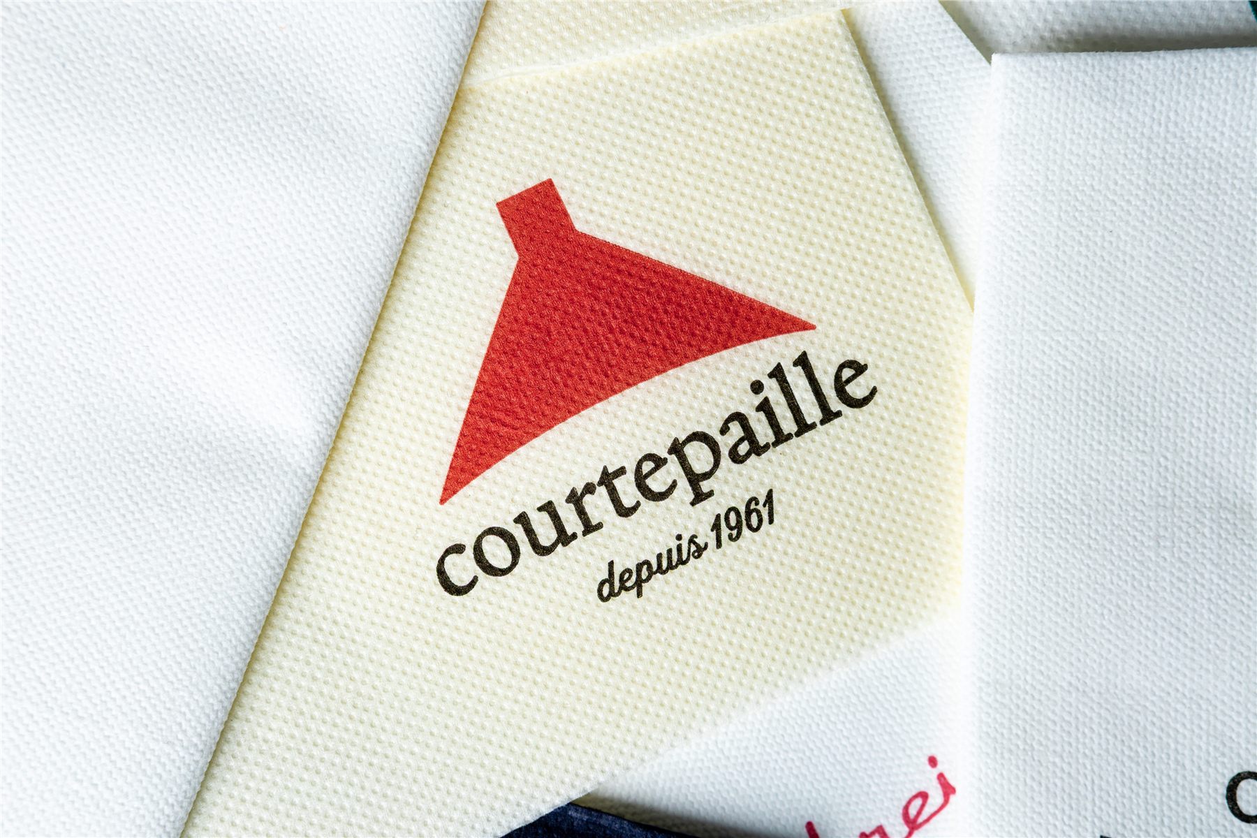Close-up of a logo-printed napkin in cream