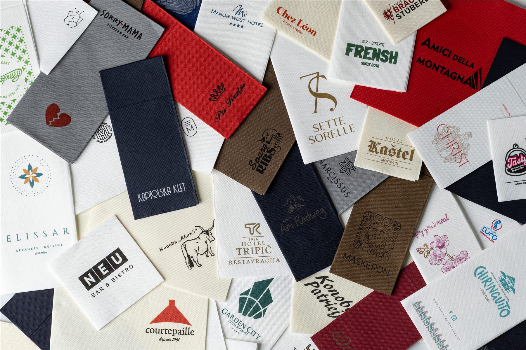 Flat lay of personalized napkins across a range of colors