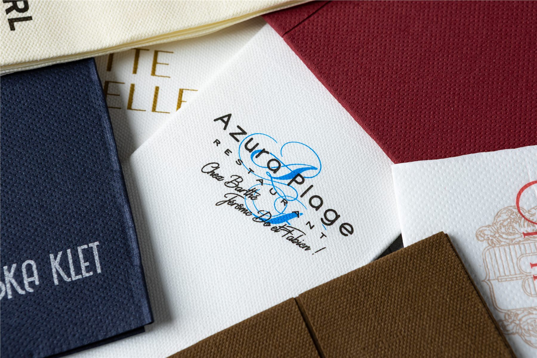 Close-up of logo-printed napkins in white and navy